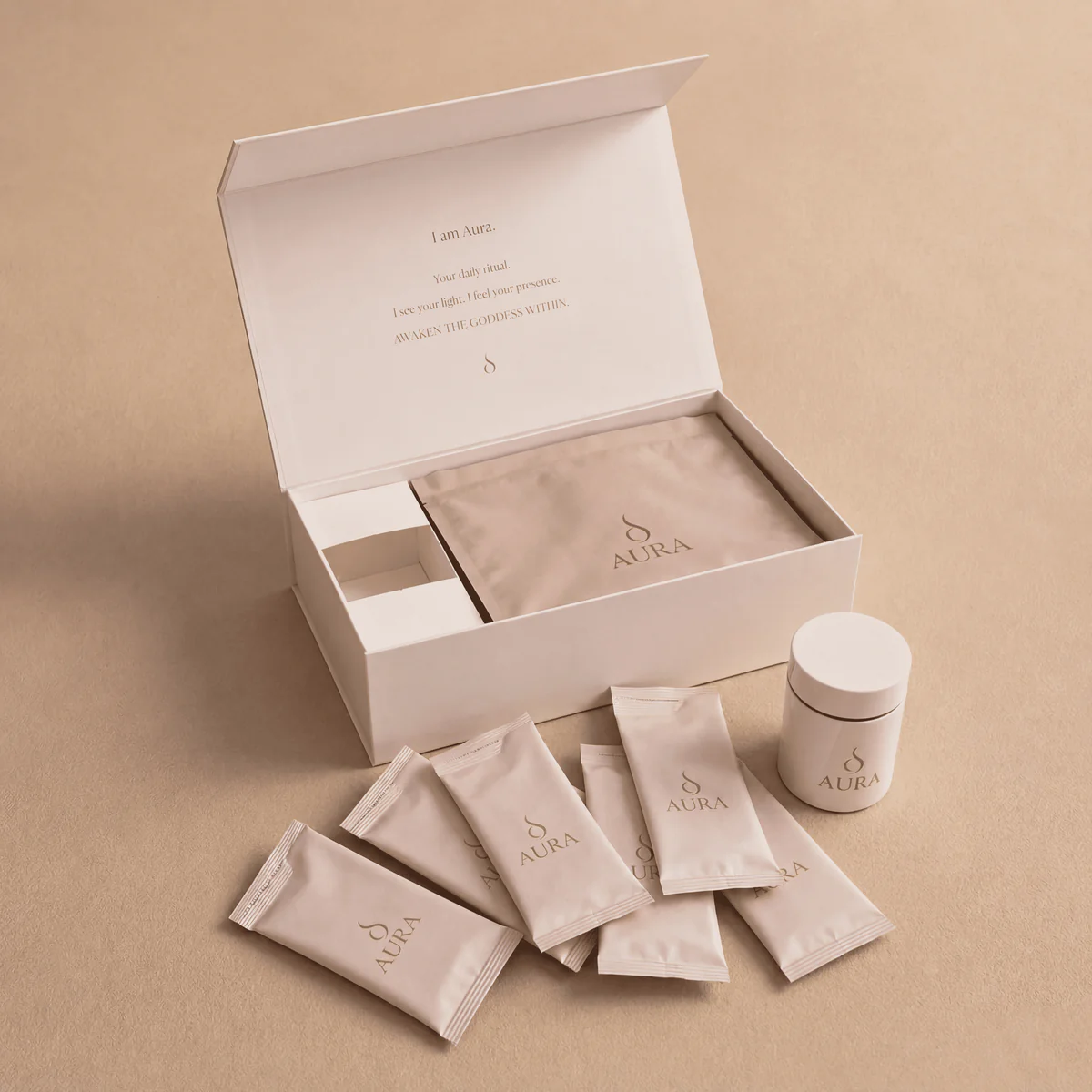 The AURA ritual box, open, with 30 pre-dosed sachets and the AURA shaker